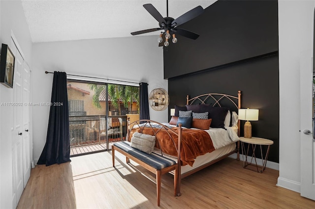 bedroom featuring access to exterior, ceiling fan, high vaulted ceiling, light hardwood / wood-style floors, and a closet