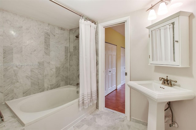 bathroom with sink, shower / bath combination with curtain, and wood-type flooring