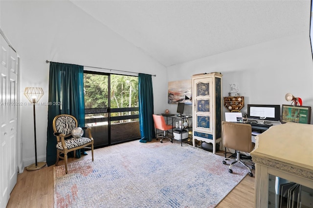 office area with high vaulted ceiling and wood-type flooring