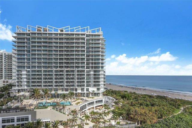 view of property featuring a water view and a beach view