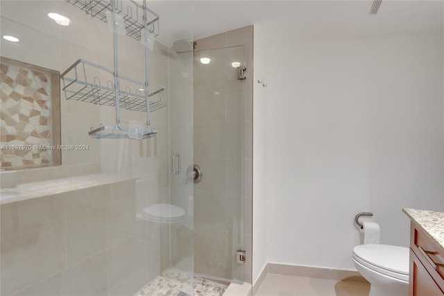 bathroom with tile patterned flooring, toilet, vanity, and walk in shower