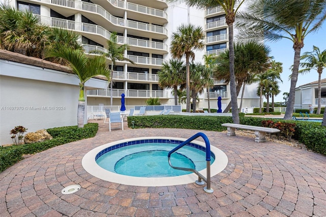 view of pool with a patio area and a hot tub