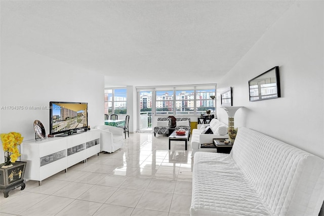 living room featuring floor to ceiling windows, light tile patterned floors, and a textured ceiling