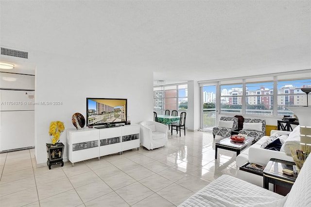 living room with light tile patterned flooring and a textured ceiling