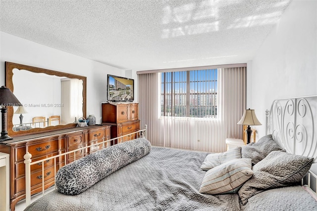 carpeted bedroom with a textured ceiling