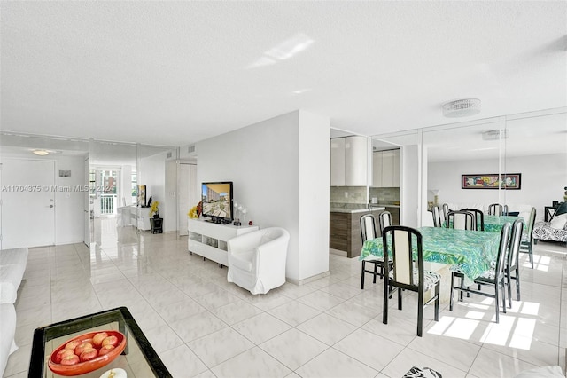 dining space featuring a textured ceiling