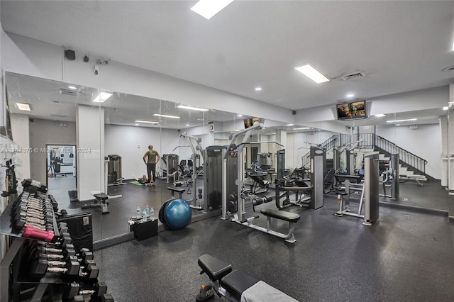 workout area with a textured ceiling