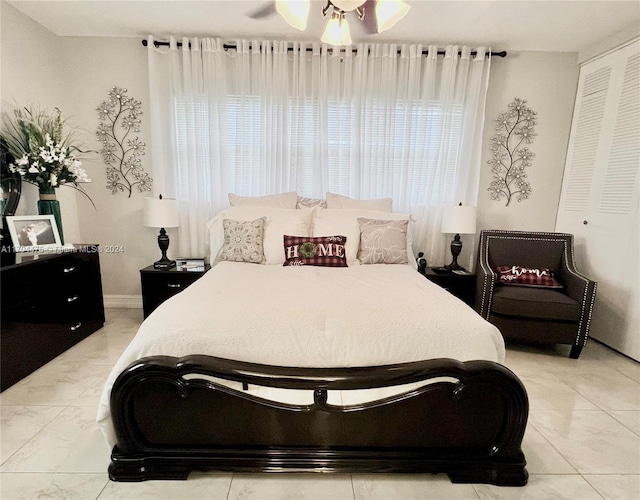 bedroom featuring multiple windows, a closet, and ceiling fan