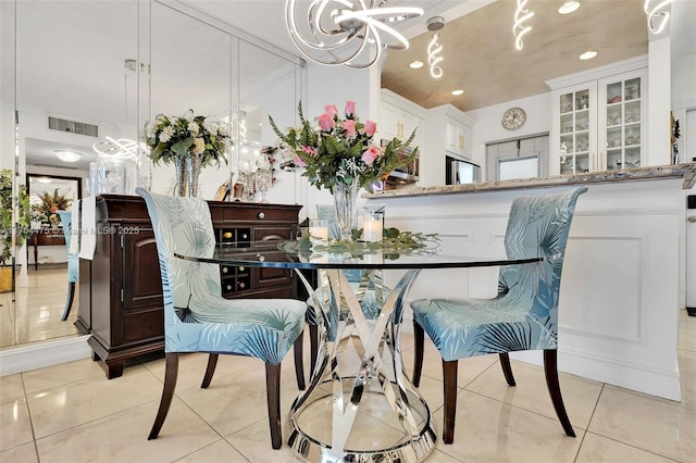 dining room with light tile patterned flooring and a notable chandelier