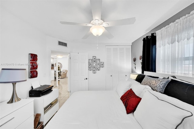 tiled bedroom featuring a closet and ceiling fan