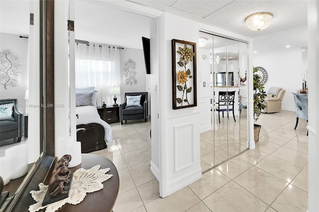 hall featuring light tile patterned floors