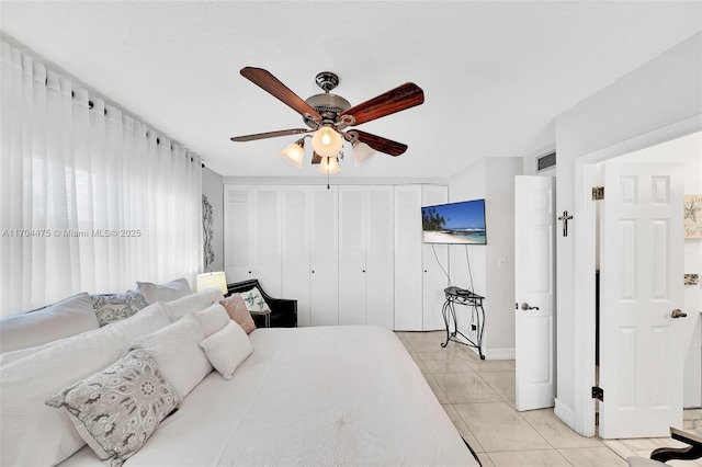 tiled bedroom with ceiling fan