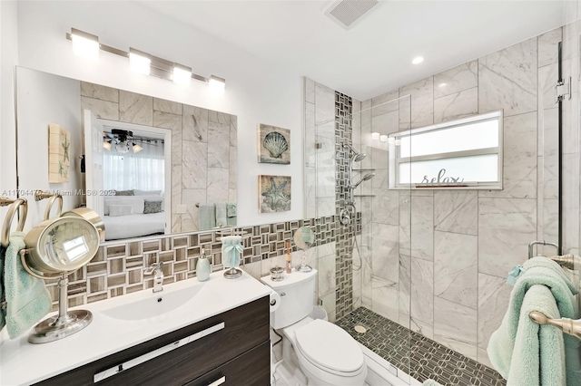 bathroom with tile walls, backsplash, vanity, toilet, and a shower with door