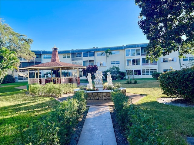 surrounding community with a yard and a gazebo