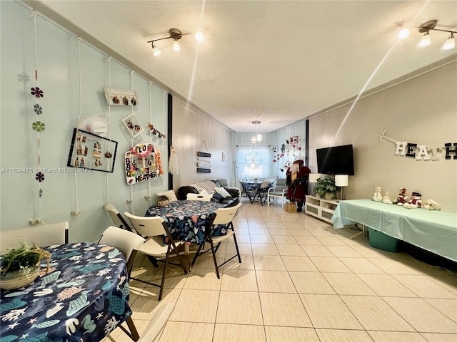 dining room with light tile patterned flooring and a textured ceiling