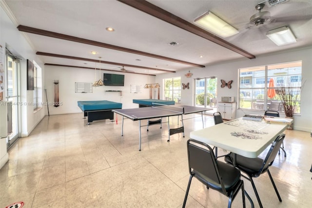 playroom with ceiling fan, ornamental molding, and beam ceiling