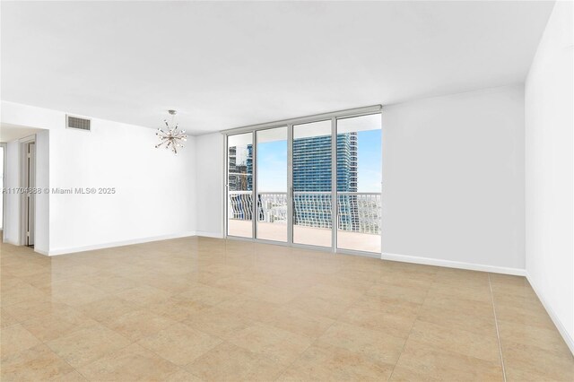 tiled spare room with floor to ceiling windows