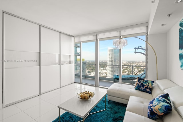 tiled living room featuring expansive windows, a healthy amount of sunlight, and a notable chandelier