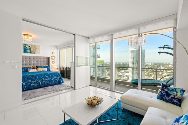 bedroom featuring a wall of windows, access to exterior, and a notable chandelier