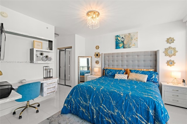 tiled bedroom featuring a notable chandelier, built in desk, and a closet