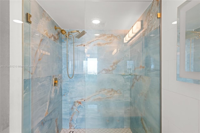 bathroom with a shower with shower door