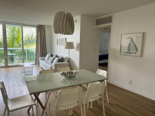 dining space with wood-type flooring