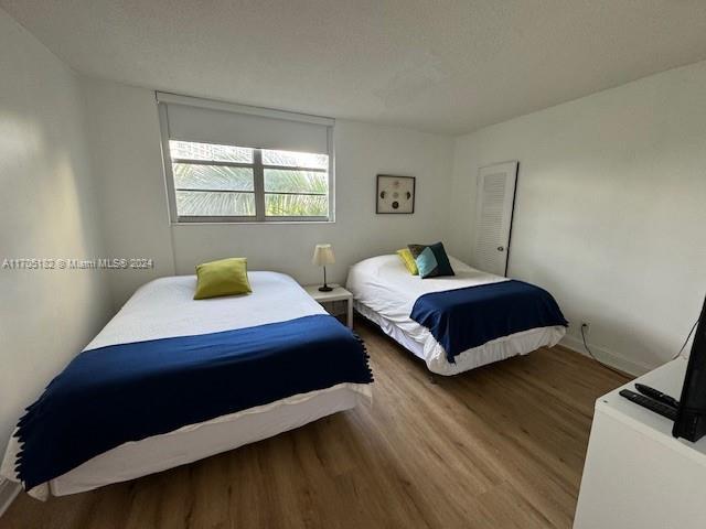 bedroom with wood-type flooring and a textured ceiling