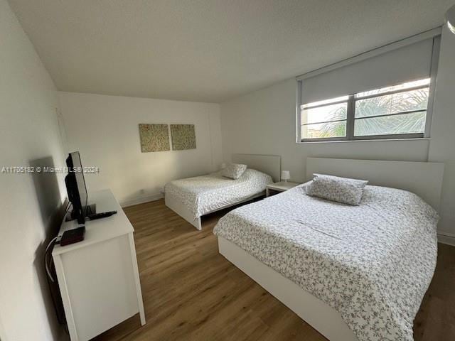 bedroom featuring dark hardwood / wood-style flooring