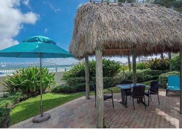 view of patio featuring a gazebo and a water view