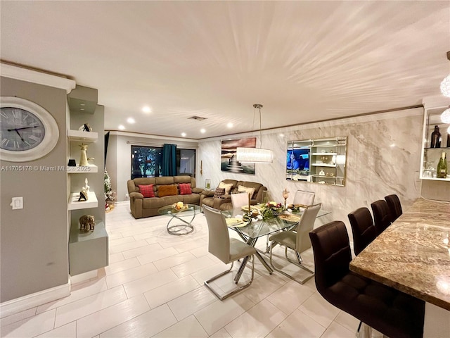 living room featuring built in shelves, light tile patterned floors, and crown molding