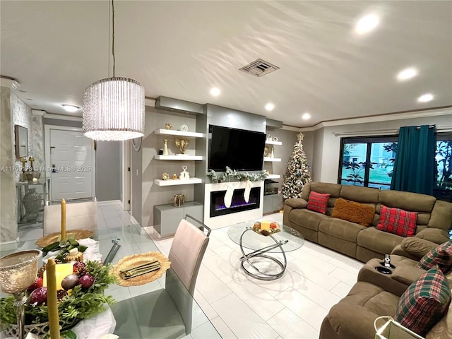 living room featuring crown molding and built in shelves