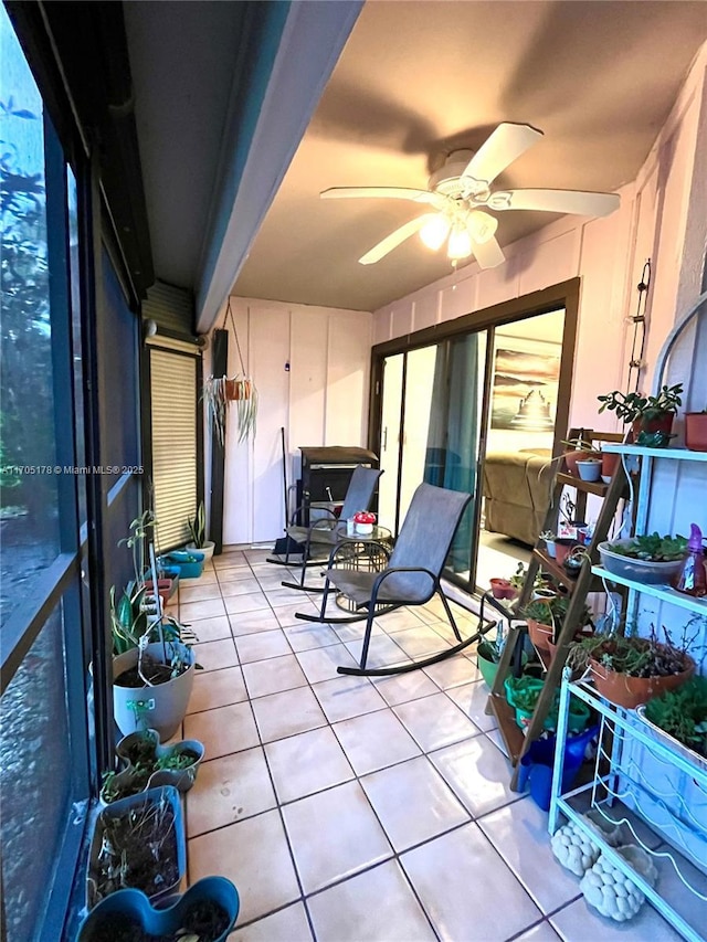 sunroom / solarium featuring ceiling fan