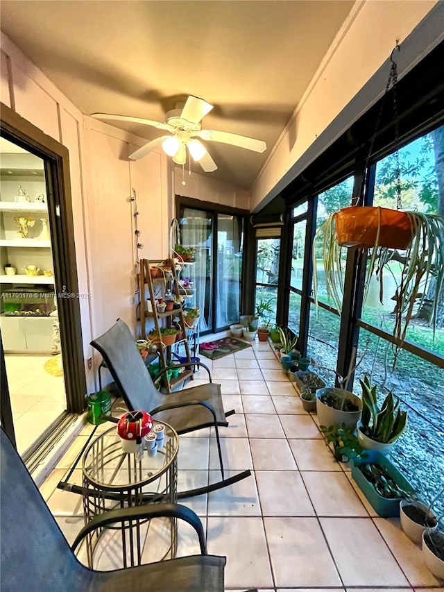 sunroom / solarium featuring ceiling fan