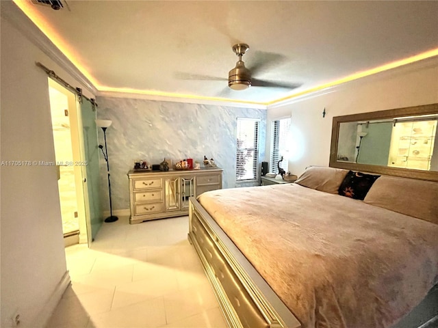 bedroom featuring ceiling fan, ornamental molding, and a barn door