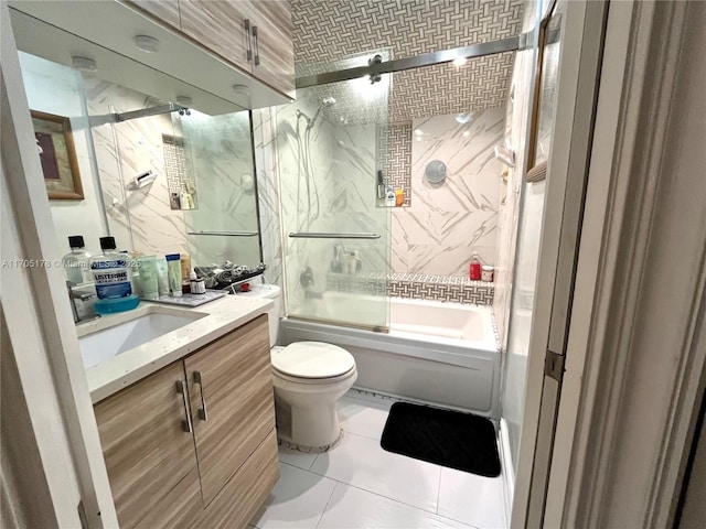 full bathroom with toilet, vanity, tile patterned flooring, and shower / bath combination with glass door