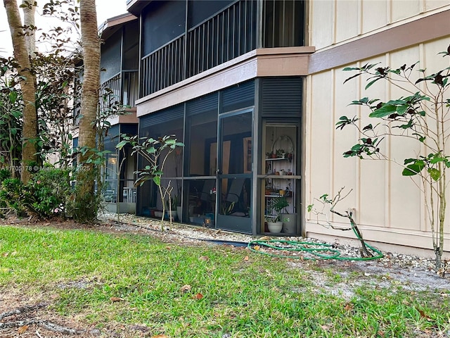 view of exterior entry with a lawn