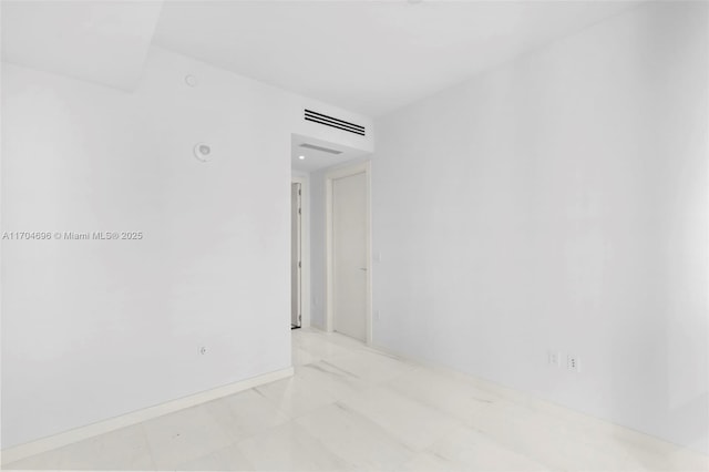 unfurnished room featuring visible vents