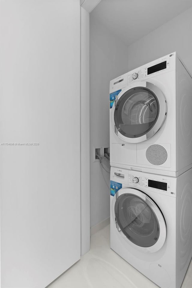 washroom featuring laundry area and stacked washer and clothes dryer