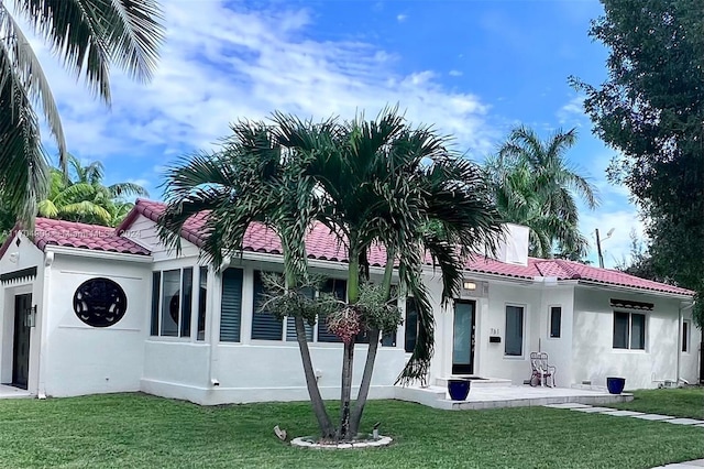 rear view of property with a yard