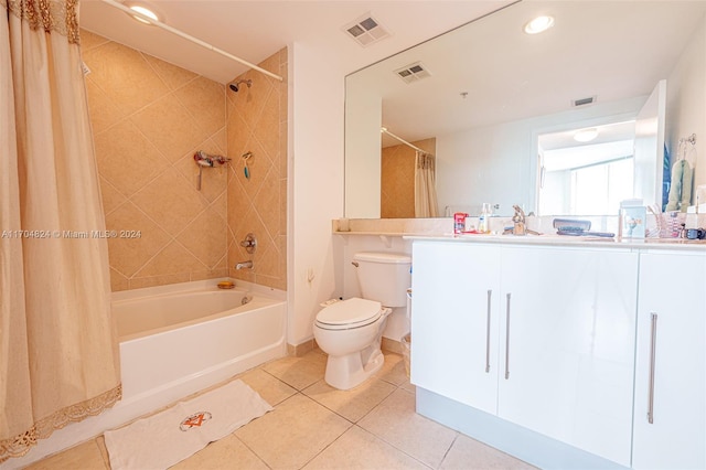 full bathroom with tile patterned floors, shower / bath combo with shower curtain, vanity, and toilet