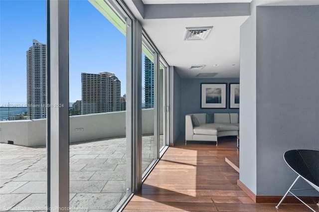 hall with hardwood / wood-style floors