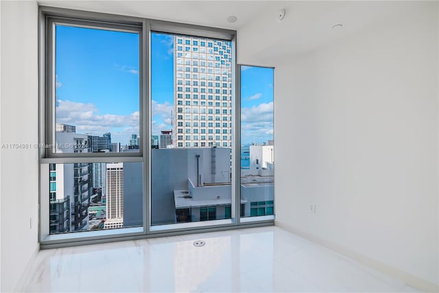 tiled spare room with expansive windows