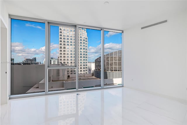 unfurnished room featuring floor to ceiling windows