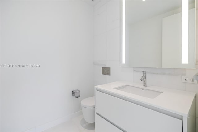 bathroom with tile patterned floors, vanity, and toilet