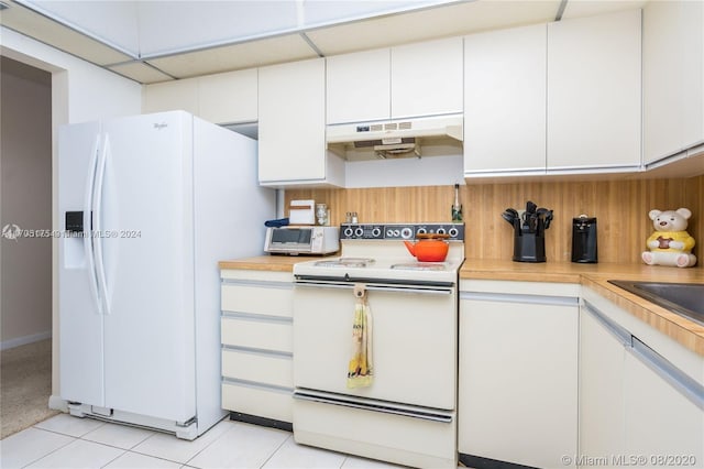 kitchen featuring white cabinetry, white appliances, and light tile patterned floors