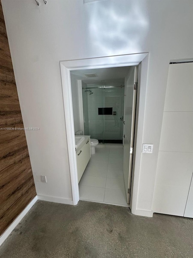 hallway featuring wood walls