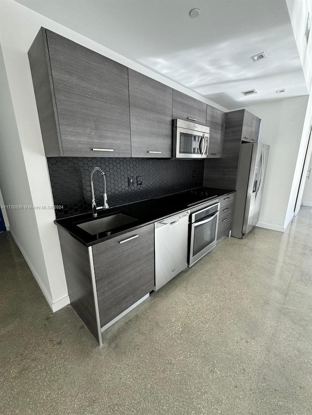 kitchen featuring tasteful backsplash, sink, and stainless steel appliances