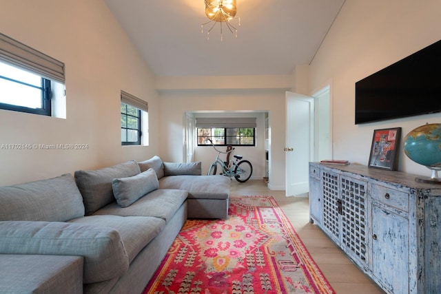 living room with light hardwood / wood-style floors and lofted ceiling