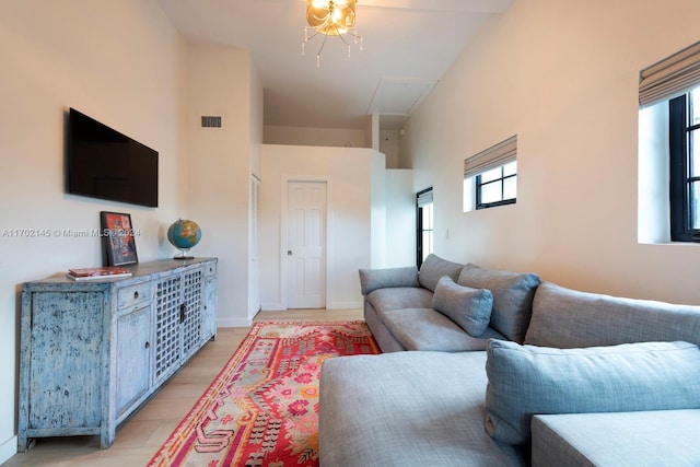 living room with high vaulted ceiling and a chandelier