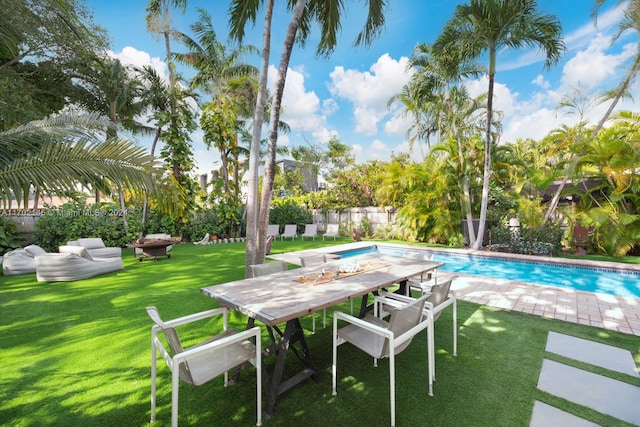 view of swimming pool with a lawn